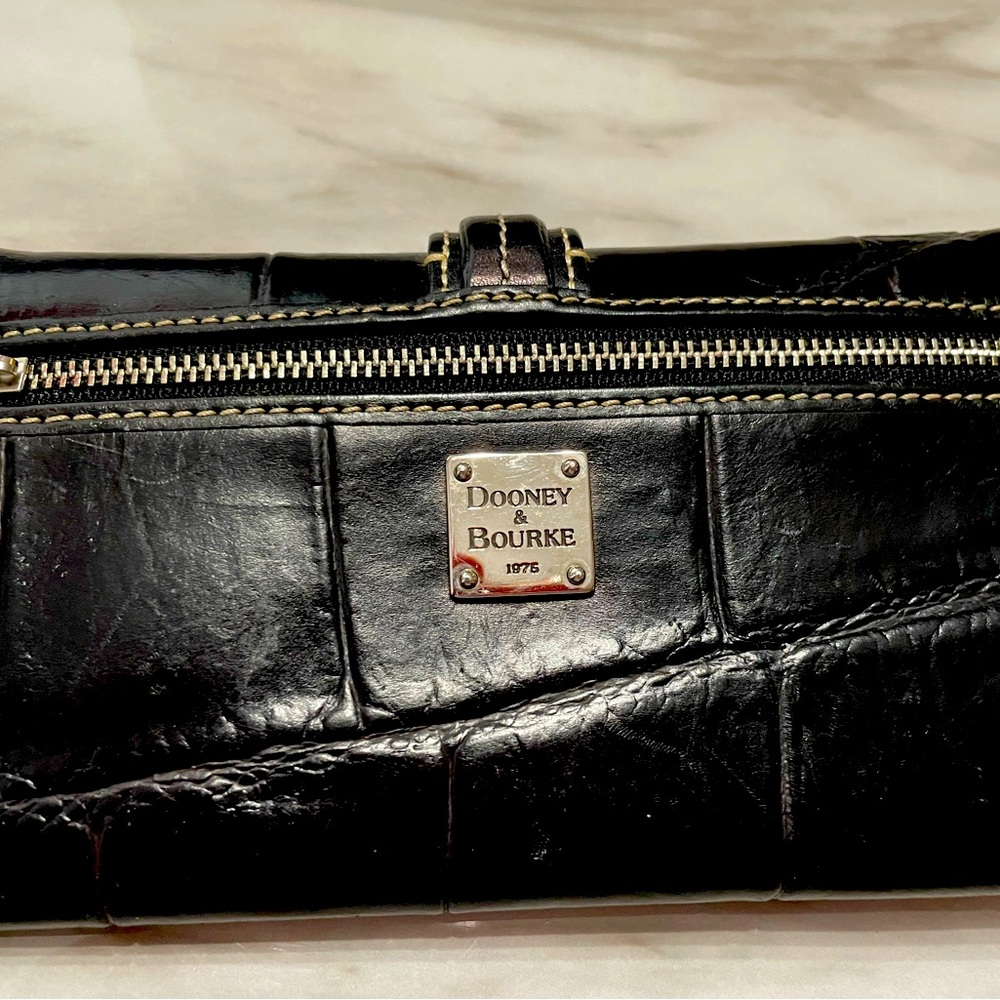 Black Dooney & Bourke women’s wallet. Wallet interior color is red.
